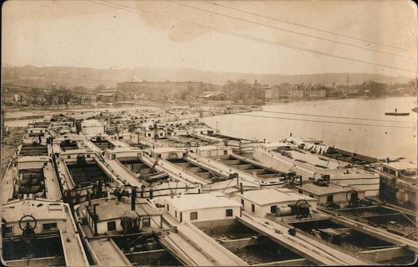 Many barges along a river bank