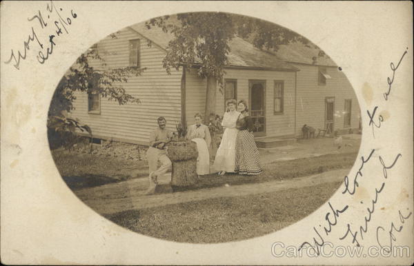 Family Posing In Front of Home