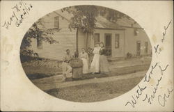 Family Posing In Front of Home